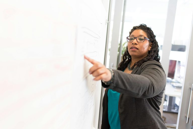 Confident businesswoman making a point during a presentation in an office setting.